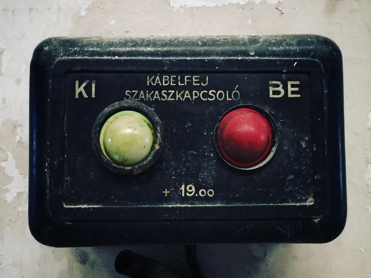 An old two-button electrical switch labeled in Hungarian