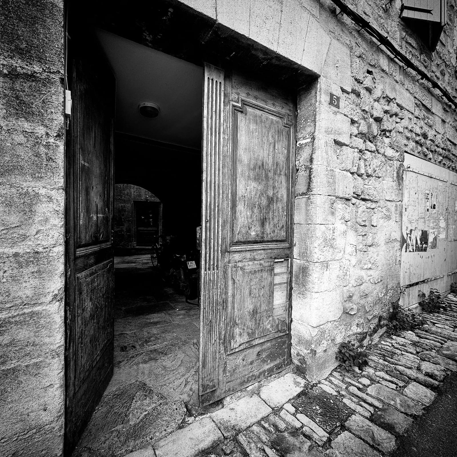 An open doorway casting light into a dark room